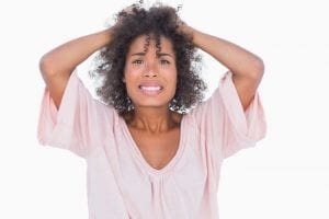 stressed out woman pulling her hair because of anxiety