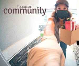 woman finding joy by delivering groceries to her neighbours during a pandemic to show her support for her community