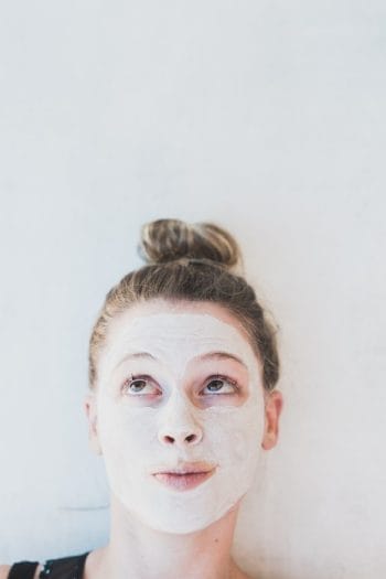 picture of a woman with acne cream on her skin wondering about natural treatment for acne with a naturopath